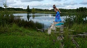 A lady poses elegantly on the lake in her bikini