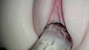 Massive crystal cock slides into tight pink pussy close-up