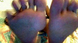 An ebony girl plays toe jerk game with instructions