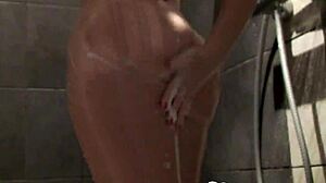 cute babe with big boobs enjoys a steamy shower moment.