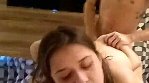 this young wife sucks a huge cock while her husband pounds her in a steamy ménage.