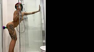 tattooed teen girl bangs her toy in steamy shower play