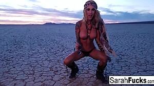 sexy tattooed hottie strips on the bed by the lake