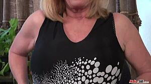 Granny flaunts big tits in wild solo play!