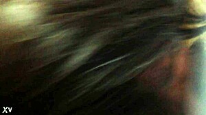 A transgender person in crossdressing attire engages in deep throat activity.