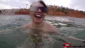 big tits girl gives handjob on public beach