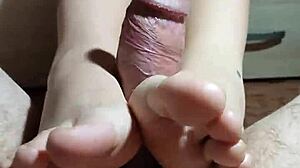 how does the asian girl satisfy the cock with her legs and hands?
