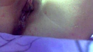 In the bedroom, she masturbates her shaved pussy with toys until a cumshot