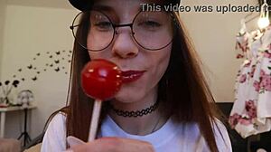 nothing unusual, just a girl sucking on a lollipop while clothed