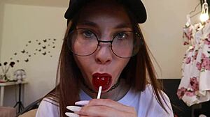 nothing unusual, just a girl sucking on a lollipop while clothed