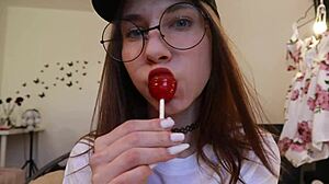 nothing unusual, just a girl sucking on a lollipop while clothed