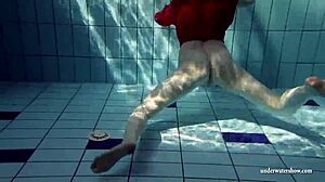 Russian teen Lucie swims underwater in the pool