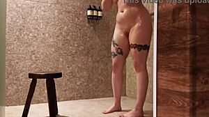 Hotel guest flashes tits and masturbates pussy in shower