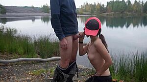 brunette couple has outdoor blowjob by lake, swallows cum