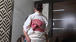 Bathrobe-Clad Mature Woman Engages in Intimate Encounter