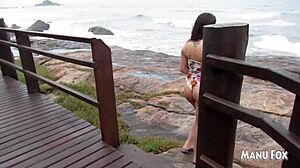 latina pornstar masturbates on the beach, fingering her big tits and ass