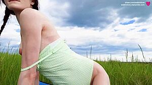 Cute Girl with Pigtails Devours Protein Snack Outdoors in Bodysuit