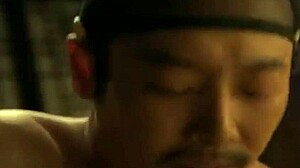 在这个韩国BDSM场景中，丰满的亚洲奴隶向主人屈服于软核亲吻和乳房玩弄