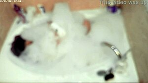 A young asian amateur enjoys a relaxing bubble bath in the bathroom, showcasing his feet and naked body.