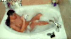 A young asian amateur enjoys a relaxing bubble bath in the bathroom, showcasing his feet and naked body.