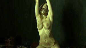 chained up woman masturbating in bdsm costume