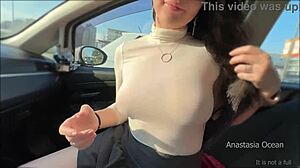 Brunette plays with cock in public parking slot daytime