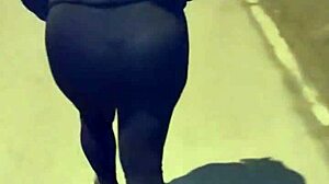 Mature woman with huge ass in transparent leggings walks the street