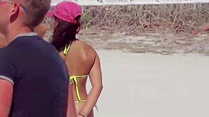 Awesome young girl in micro bikini on the beach with relatives
