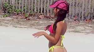 Awesome young girl in micro bikini on the beach with relatives