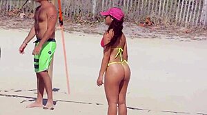 Awesome young girl in micro bikini on the beach with relatives
