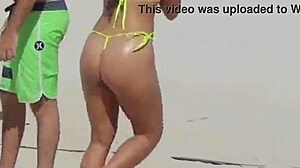 Awesome young girl in micro bikini on the beach with relatives