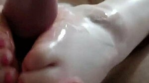 Big ass amateur Joan Day gives casual footjob.