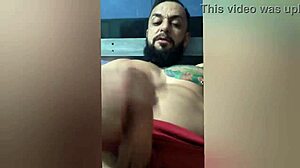 Watch this Brazilian amateur with pierced nipples and tattoos stroking her hard cock on the bed