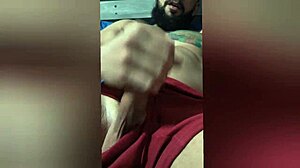Watch this Brazilian amateur with pierced nipples and tattoos stroking her hard cock on the bed