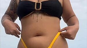 i'm wearing tight bikini to show swollen pussy on beach