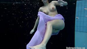 Aneta flaunts big tits in purple dress during pool dip