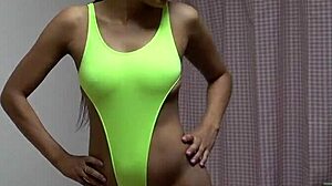 Tanned japanese girl with perfect body changes naked to yellow thong leotard for athletic workout
