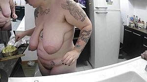Hey, watch this curvy Brazilian housewife doing dishes naked with her big natural tits out.