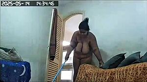 Hidden camera catches busty Brazilian BBW maid cleaning house naked, showing huge tits and ass