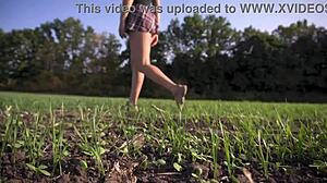 Hot schoolgirl in uniform strolls outdoors while flashing her full back panties upskirt.