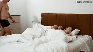 Step mom and step sister shared the bed with step son during naughty hotel romp. They fingered pussy and gave facial cumshot.