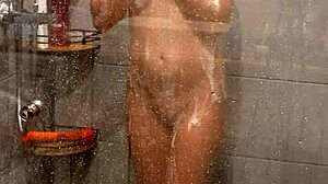 This hot milf strips down in the shower, fingering her shaved pussy with a magic wand until she hits multiple orgasms.