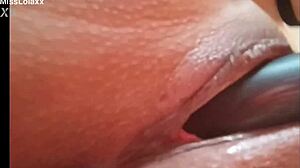 Sensual latina teen masturbates with dildo on bed showing wet pussy lips close-up