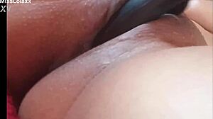 Sensual latina teen masturbates with dildo on bed showing wet pussy lips close-up