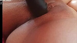 Sensual latina teen masturbates with dildo on bed showing wet pussy lips close-up