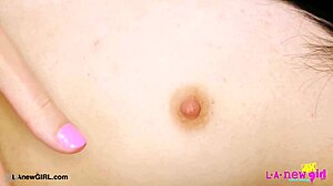 Picture-perfect brunette teen poses on sofa to reveal her sexy petite body during photoshoot.