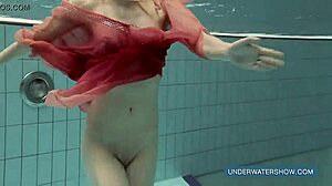 Brunette teen Katya Okuneva poses in red dress by the pool