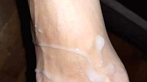 she strokes his throbbing cock between her creamy toes until feet explode