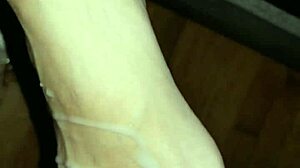 she strokes his throbbing cock between her creamy toes until feet explode